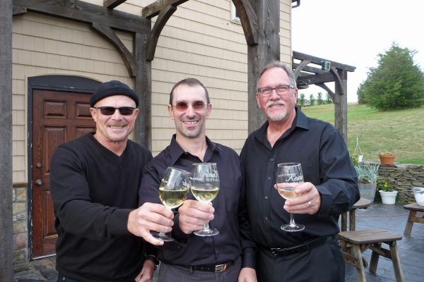 Band Members in Artistic License toast a glass of Keuka Spring wine