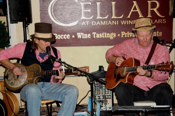 The Bollicini Brothers on Cellar stage playing guitar