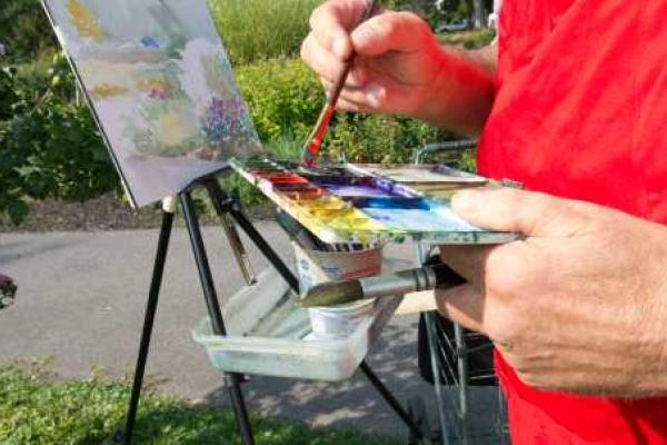 Artist with paint and easel