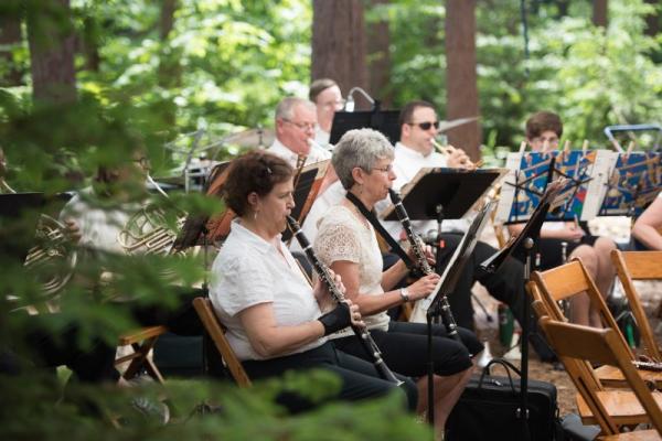Finger Lakes Symphony Orchestra playing in the pine trees