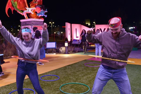 Two guests using hula-hoops in the Strong's outdoor Hasbro Game Park.
